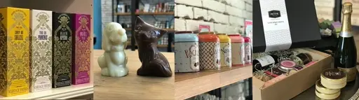 Verschiedene dekorative Keramikfiguren und bunte Teedosen auf einem Regalbrett neben Schmuck und Parfümflakons.