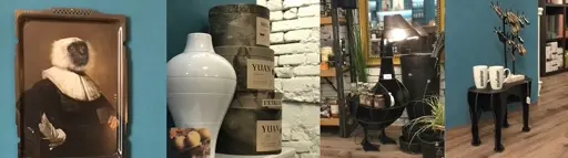 Antikes Porträtbildnis in dunklem Holzrahmen mit weißer Kleidung, große weiße Keramikvase mit Fruchtmotiv, schwarzer Metallteller mit Holzgriffen, zwei weiße Keramikbecher auf schwarzem Tisch.