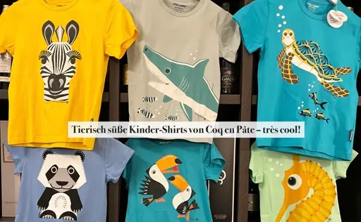 Kinder-Shirts mit bedruckten Tieren wie Zebra, Hai, Schildkröte, Panda, Tukan und Fisch in Gelb, Blau und Grün.